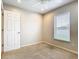 Bedroom featuring neutral carpet, a window with blinds and a door to hallway at 2641 Delcrest Dr, Orlando, FL 32817