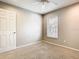 Bedroom featuring neutral carpet, a ceiling fan, and a window with blinds and a door to hallway at 2641 Delcrest Dr, Orlando, FL 32817