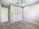 Bedroom with neutral carpet and a closet with white louvered doors and a door to hallway at 2641 Delcrest Dr, Orlando, FL 32817
