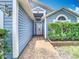 Entrance with blue siding, brick walkway and covered entryway at 2641 Delcrest Dr, Orlando, FL 32817