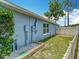 Rear exterior of light blue home with white fence and manicured lawn at 2641 Delcrest Dr, Orlando, FL 32817