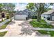 Charming blue house with a well-manicured lawn, mature trees and a two-car garage at 2641 Delcrest Dr, Orlando, FL 32817