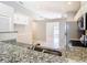 Modern kitchen featuring granite countertops, stainless steel appliances, and ample cabinet space at 2641 Delcrest Dr, Orlando, FL 32817