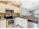 Well-equipped kitchen with stainless steel appliances, tile backsplash, and granite counters at 2641 Delcrest Dr, Orlando, FL 32817