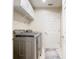 Laundry room includes a washer/dryer set and overhead storage shelving at 2641 Delcrest Dr, Orlando, FL 32817