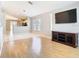 Inviting living room with hardwood floors, entertainment center and access to the kitchen at 2641 Delcrest Dr, Orlando, FL 32817