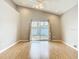 Bright living room with hardwood floors, ceiling fan, and sliding glass doors to outdoor patio at 2641 Delcrest Dr, Orlando, FL 32817