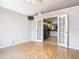 Living room featuring hardwood floors, neutral walls, and french doors leading to kitchen at 2641 Delcrest Dr, Orlando, FL 32817