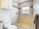 Nicely tiled shower with bench seating and decorative mosaic stripe at 2641 Delcrest Dr, Orlando, FL 32817