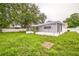 Spacious backyard featuring a screened lanai, partial fencing, and lush greenery, perfect for outdoor living at 7331 Blue Jacket W Pl, Winter Park, FL 32792