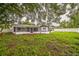 Backyard with a screened lanai and a white picket fence offering both privacy and a defined outdoor area at 7331 Blue Jacket W Pl, Winter Park, FL 32792
