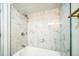 Bathroom showcasing a tiled bathtub, modern fixtures, and marble accents, offering a luxurious bathing experience at 7331 Blue Jacket W Pl, Winter Park, FL 32792