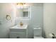 Updated bathroom with sleek vanity, modern lighting, gold fixtures, and a toilet, designed for comfort and style at 7331 Blue Jacket W Pl, Winter Park, FL 32792