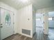 Inviting foyer featuring decorative front door, and neutral paint complemented by wood-look floors at 7331 Blue Jacket W Pl, Winter Park, FL 32792