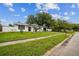 Charming home featuring a well-manicured lawn, a neat sidewalk, and a lovely street view at 7331 Blue Jacket W Pl, Winter Park, FL 32792