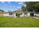 Charming single-story home with a well-maintained lawn and landscaping, set under a partly cloudy sky at 7331 Blue Jacket W Pl, Winter Park, FL 32792