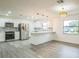 Bright kitchen boasts modern stainless steel appliances, stylish tile backsplash, and eat-in breakfast bar at 7331 Blue Jacket W Pl, Winter Park, FL 32792