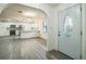 Bright, open-concept kitchen featuring stainless steel appliances, white cabinetry, and a stylish mosaic backsplash at 7331 Blue Jacket W Pl, Winter Park, FL 32792
