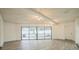 Open living area with beamed ceiling and glass doors to backyard at 7331 Blue Jacket W Pl, Winter Park, FL 32792