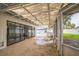 Enclosed back patio with screened walls and transparent ceiling, featuring a hot tub and access to the backyard at 7331 Blue Jacket W Pl, Winter Park, FL 32792