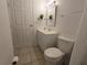 Bright bathroom featuring a white vanity, framed mirror, and tile flooring at 4213 E Michigan St # 4213, Orlando, FL 32812
