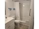 Bright bathroom featuring a shower-tub combo with safety bar, a toilet, and a vanity with a sink at 4213 E Michigan St # 4213, Orlando, FL 32812