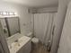 Neutral bathroom with toilet, sink and vanity, framed mirror, and tub with shower at 4213 E Michigan St # 4213, Orlando, FL 32812