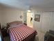 Comfortable bedroom with a ceiling fan and a red and white checkered comforter at 4213 E Michigan St # 4213, Orlando, FL 32812