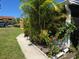 Exterior view showcasing the property's landscaping, including palm trees and colorful flowering plants at 4213 E Michigan St # 4213, Orlando, FL 32812