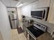 Efficient kitchen with stainless steel appliances, granite countertops, and ample cabinet space at 4213 E Michigan St # 4213, Orlando, FL 32812