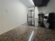 Well-lit kitchen features granite counters, sleek black cooktop, and stainless steel refrigerator at 4213 E Michigan St # 4213, Orlando, FL 32812