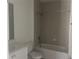 Bathroom featuring a bathtub and shower combination with sleek fixtures and a bright mirror at 3069 Caribbean Soul Dr, Kissimmee, FL 34747
