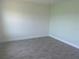 Minimalist bedroom with grey tile flooring and neutral walls at 3069 Caribbean Soul Dr, Kissimmee, FL 34747