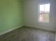 Bright bedroom with tiled floors, green walls, and a window view at 3069 Caribbean Soul Dr, Kissimmee, FL 34747