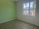 Cozy bedroom featuring bright green walls and a light-filled window at 3069 Caribbean Soul Dr, Kissimmee, FL 34747