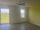 Open living room area with a ceiling fan and access to the backyard view at 3069 Caribbean Soul Dr, Kissimmee, FL 34747