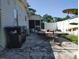 Backyard view with trash cans and a trailer on a concrete surface at 6971 Pompeii Rd, Orlando, FL 32822