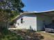 Side exterior showcasing the home's structure with vinyl siding and an adjacent open area at 6971 Pompeii Rd, Orlando, FL 32822