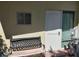 Exterior shot of a home with a weathered bench, window, door and electric meter at 6971 Pompeii Rd, Orlando, FL 32822