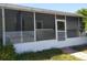 Screened-in front porch with views of the surrounding landscape and space for seating at 6971 Pompeii Rd, Orlando, FL 32822