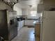 Galley-style kitchen with appliances, tile floors, and abundant cabinet space at 6971 Pompeii Rd, Orlando, FL 32822