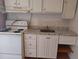 Modest kitchen features white cabinets, an oven, and a stainless-steel sink at 6971 Pompeii Rd, Orlando, FL 32822