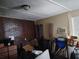 Untidy living room with a brick wall and old-style air conditioner, needing renovation at 6971 Pompeii Rd, Orlando, FL 32822