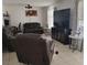 A cozy living room with plush leather seating, modern decor, and a large flat-screen TV at 6971 Pompeii Rd, Orlando, FL 32822