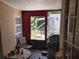 Enclosed porch features outdoor access and a barbecue grill, creating a cozy outdoor space at 6971 Pompeii Rd, Orlando, FL 32822