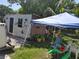 Exterior view of a weather beaten shed featuring peeling paint and a patio at 6971 Pompeii Rd, Orlando, FL 32822