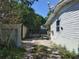 Gravel side yard featuring a small shed, providing additional storage space at 6971 Pompeii Rd, Orlando, FL 32822