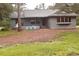 Exterior of home with green lawn, trees, and front entrance at 10411 County Road 474, Clermont, FL 34714