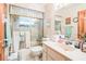 Bathroom featuring a shower and tub with a glass door, tile flooring, and a vanity at 418 W Holly Dr, Orange City, FL 32763