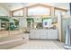 Bright bathroom with a soaking tub, tile floor, and a large vanity area at 418 W Holly Dr, Orange City, FL 32763